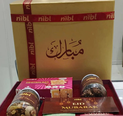 Gift set with 'nibl' branding featuring snacks and a protein bar on a white background.